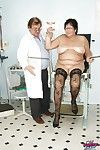 Roly-poly granny apropos stockings gets will not hear of shaved cunt examed coupled with fingered unconnected with gyno