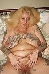 Unsightly kirmess tattooed granny spreads thither their way grey perforated pussy